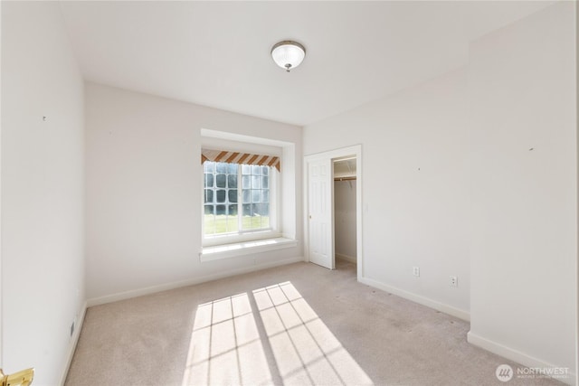 unfurnished bedroom featuring carpet floors and baseboards