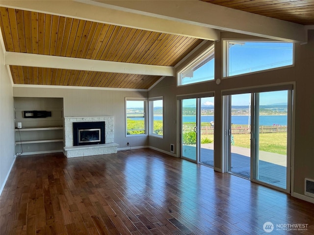 1412 Bonnie View Acres Rd, Oak Harbor, WA 98277 - unfurnished living room featuring a water view, wooden ceiling with exposed beams, a glass covered fireplace, dark wood-style floors, and baseboards