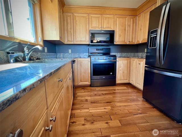 1412 Bonnie View Acres Rd, Oak Harbor, WA 98277 - kitchen with fridge with ice dispenser, black microwave, stainless steel gas range, light brown cabinets, and light wood-style flooring