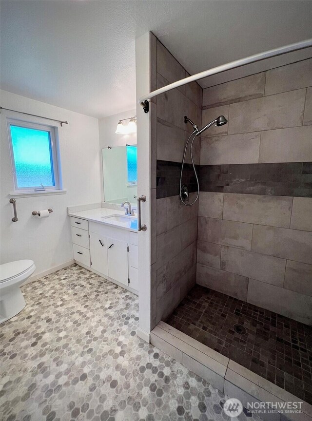 1412 Bonnie View Acres Rd, Oak Harbor, WA 98277 - full bath with vanity, a tile shower, toilet, and baseboards