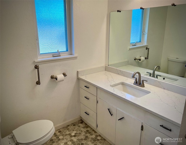1412 Bonnie View Acres Rd, Oak Harbor, WA 98277 - bathroom featuring toilet, healthy amount of natural light, vanity, and baseboards