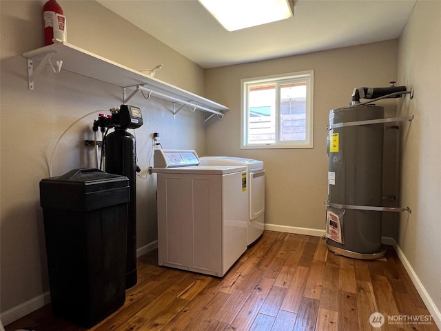 1412 Bonnie View Acres Rd, Oak Harbor, WA 98277 - washroom with washing machine and dryer, secured water heater, hardwood / wood-style flooring, and baseboards
