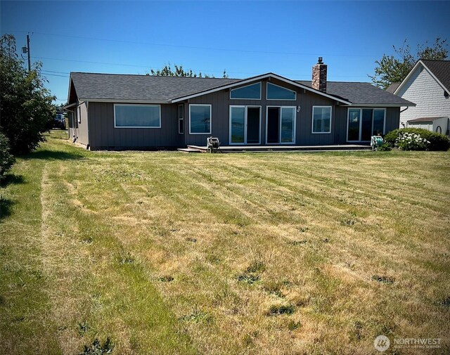 1412 Bonnie View Acres Rd, Oak Harbor, WA 98277 - back of property featuring a chimney, a yard, and roof with shingles