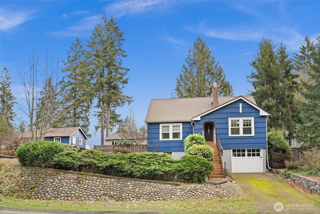 raised ranch with a chimney, stairway, fence, a garage, and driveway