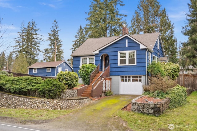 view of front facade featuring a garage, fence, dirt driveway, stairway, and a chimney