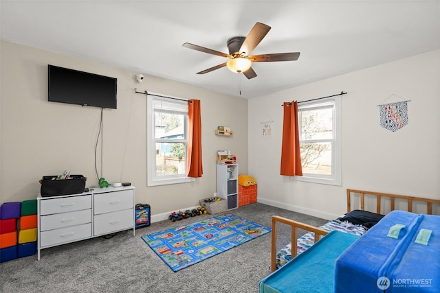 carpeted bedroom with baseboards and a ceiling fan