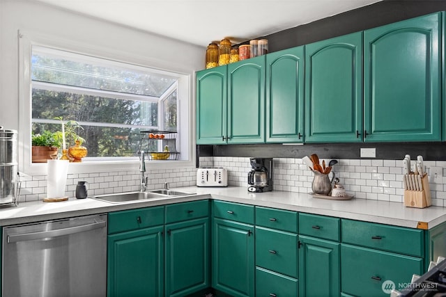 kitchen with light countertops, stainless steel dishwasher, a sink, and tasteful backsplash