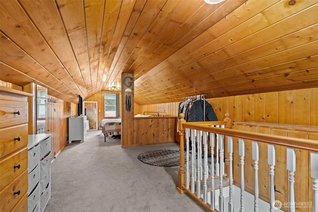 carpeted bedroom with lofted ceiling, wood walls, and wood ceiling