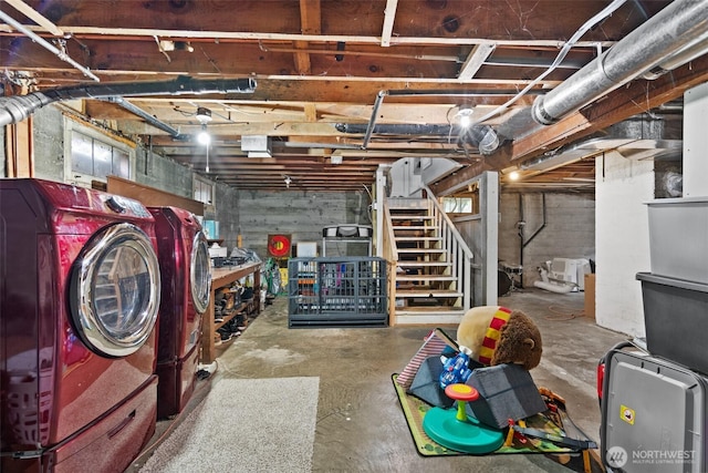 unfinished basement featuring washer and dryer and stairway