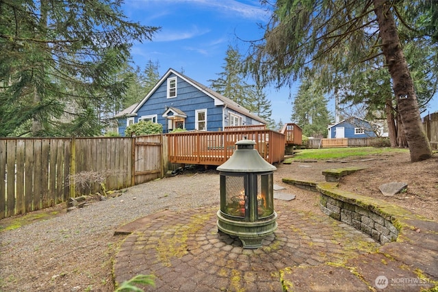 back of house featuring a deck and a fenced backyard