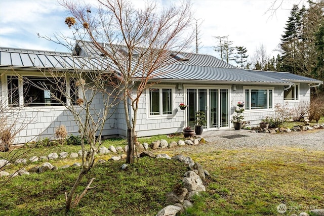 ranch-style home featuring a standing seam roof and metal roof