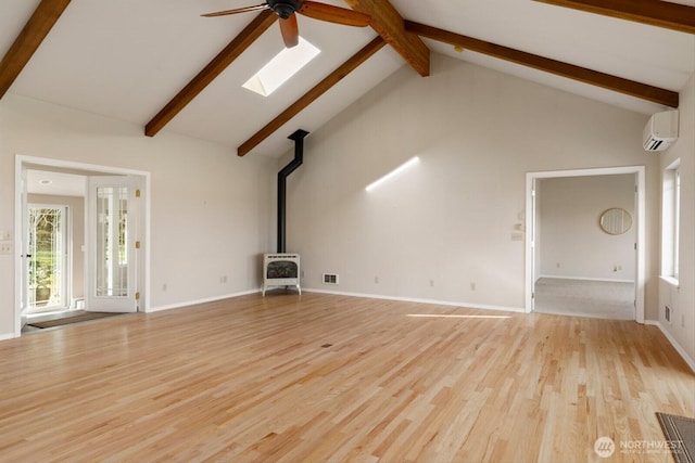 unfurnished living room featuring high vaulted ceiling, light wood-style floors, a wall mounted AC, beamed ceiling, and a wood stove