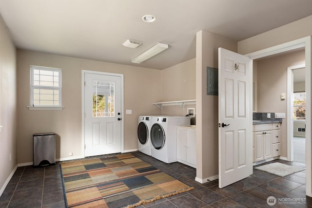 washroom featuring cabinet space, washing machine and dryer, visible vents, and baseboards