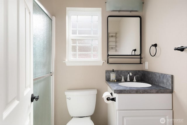 bathroom featuring vanity and toilet