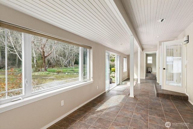 unfurnished sunroom featuring wood ceiling