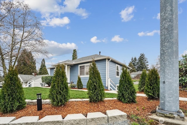 view of property exterior with a lawn