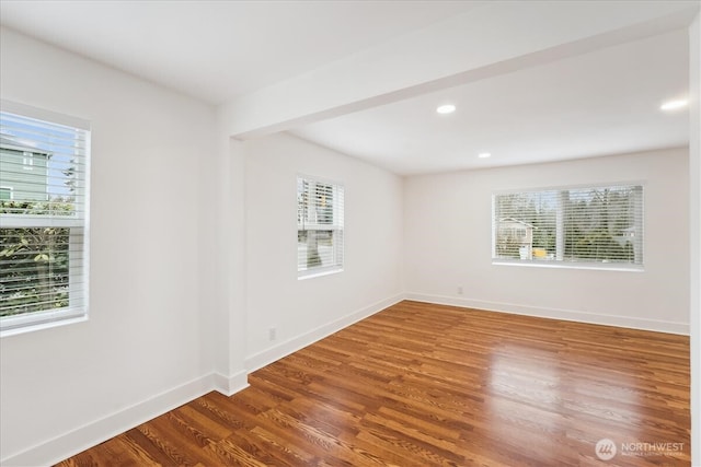 spare room with recessed lighting, baseboards, and wood finished floors