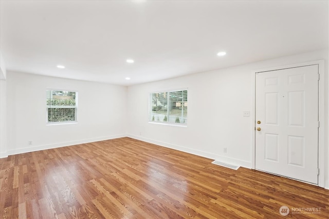 interior space with light wood-type flooring, baseboards, and recessed lighting