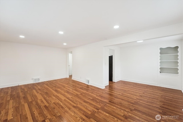 below grade area with visible vents, wood finished floors, and recessed lighting