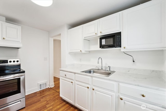 kitchen featuring black microwave, under cabinet range hood, a sink, visible vents, and stainless steel electric stove