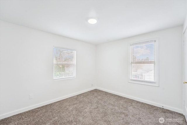 empty room with carpet flooring and baseboards