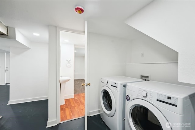 laundry room featuring laundry area, separate washer and dryer, and wood finished floors