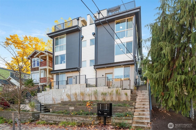 back of property featuring stairway