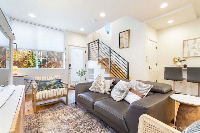 living area featuring stairs, recessed lighting, and wood finished floors