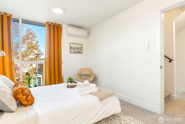 bedroom with a wall mounted air conditioner, light colored carpet, and baseboards