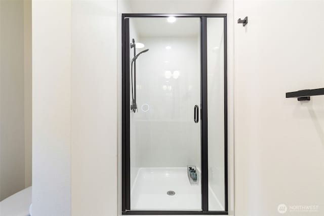 full bath featuring a shower stall