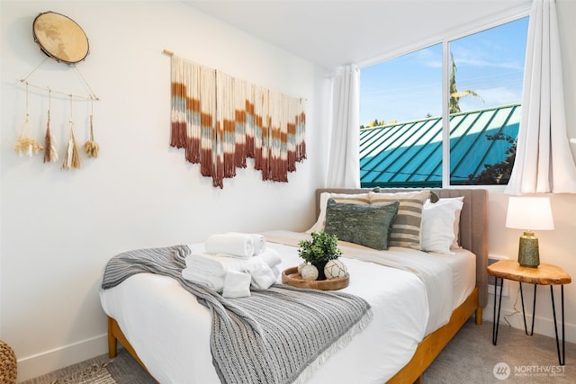 carpeted bedroom with baseboards