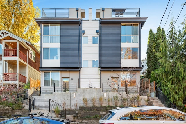 back of house featuring stairway