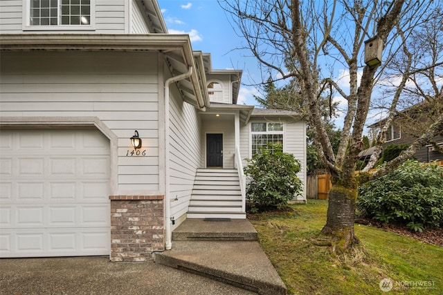 property entrance featuring a garage and brick siding