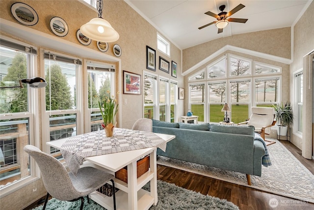 sunroom / solarium with a healthy amount of sunlight, ceiling fan, and vaulted ceiling