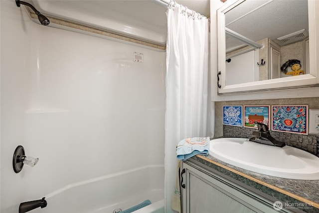 bathroom with shower / tub combo, visible vents, backsplash, and vanity