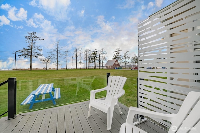 wooden terrace featuring a yard