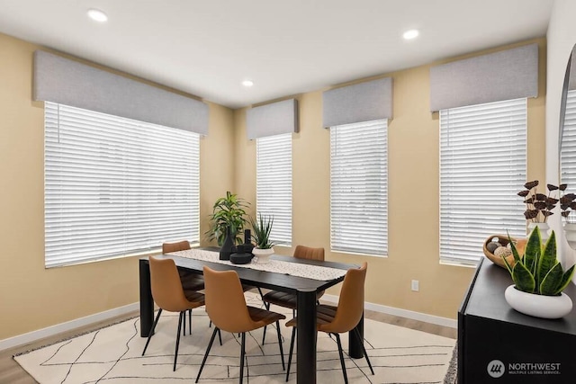 dining area with baseboards, light wood-style floors, and recessed lighting