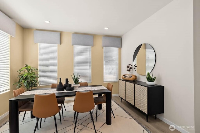 dining room with recessed lighting, light wood finished floors, and baseboards