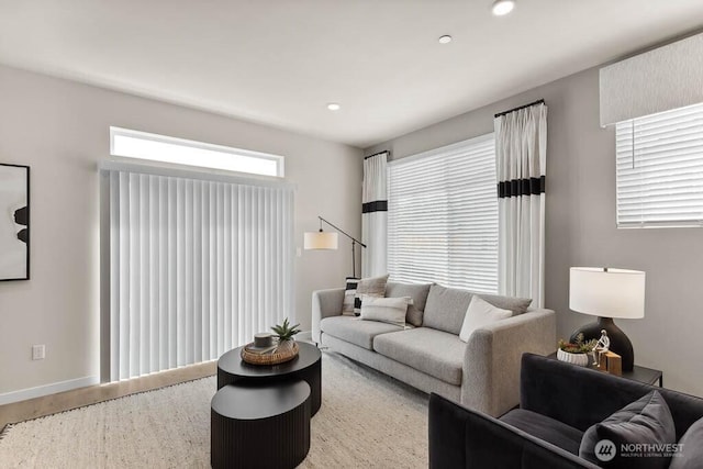 living room featuring baseboards, wood finished floors, and recessed lighting