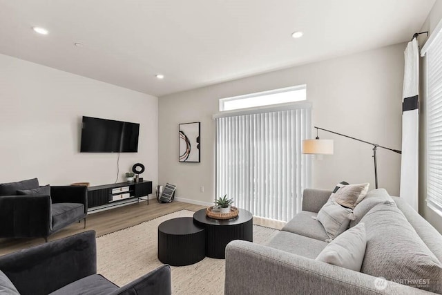 living area with light wood-style floors, baseboards, and recessed lighting