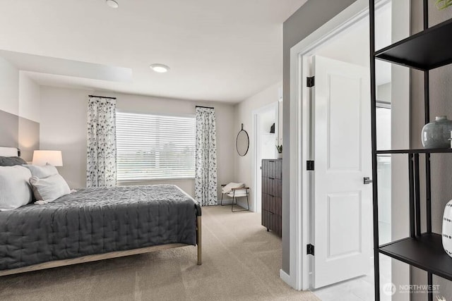 bedroom featuring light carpet