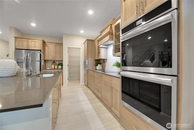 kitchen featuring light brown cabinetry, appliances with stainless steel finishes, recessed lighting, and tasteful backsplash