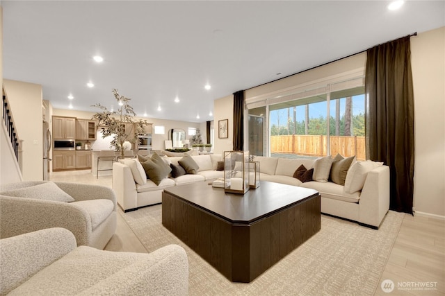 living room featuring light wood-type flooring and recessed lighting