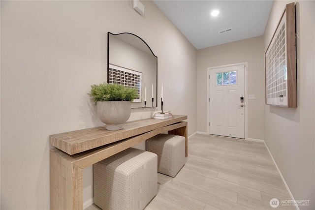 entrance foyer with light wood finished floors, baseboards, visible vents, and recessed lighting