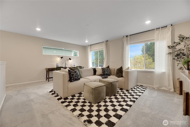 living area featuring recessed lighting, baseboards, and light colored carpet