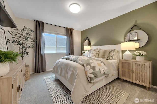 bedroom featuring baseboards and light colored carpet