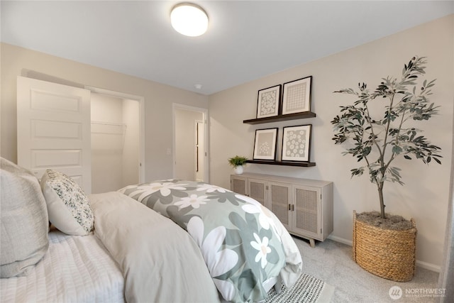 bedroom featuring light carpet and baseboards