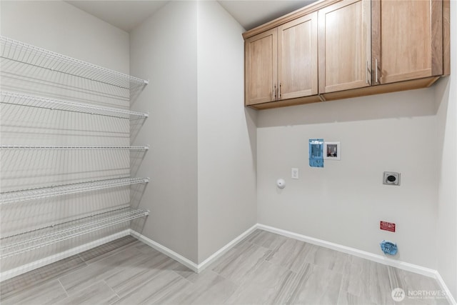 clothes washing area with cabinet space, baseboards, gas dryer hookup, hookup for a washing machine, and electric dryer hookup