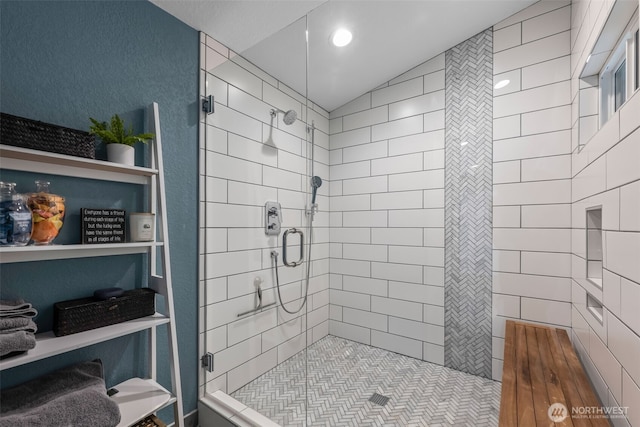 bathroom with a stall shower and lofted ceiling