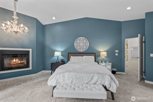 carpeted bedroom with baseboards, a glass covered fireplace, vaulted ceiling, a chandelier, and recessed lighting